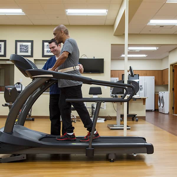African American Man on a treadmill at physical therapy
