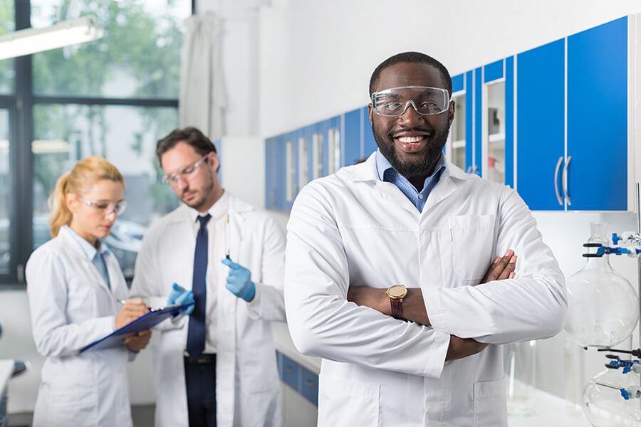 smiling doctor standing in laboratory