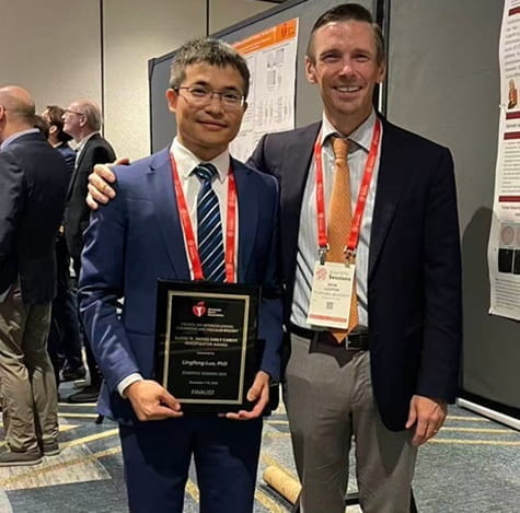 Lingfeng Luo displays his presentation plaque