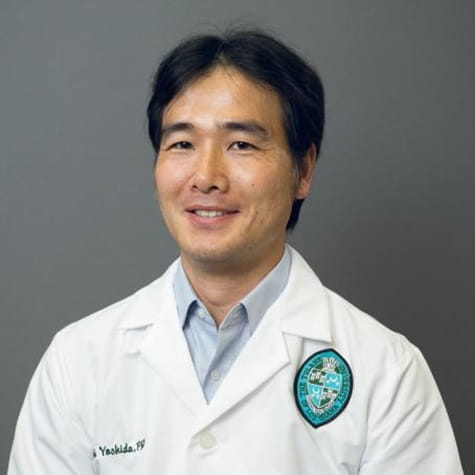 Headshot of  Tadashi Yoshida, PhD, in white lab coat