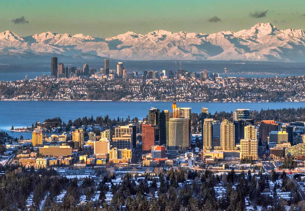 The city of Bellvue, Washington is in the foreground while Seattle rises across the water. 