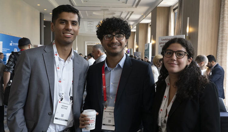 Three attendees pose during a break in Baltimore during #BCVS25, July 24, 2025.