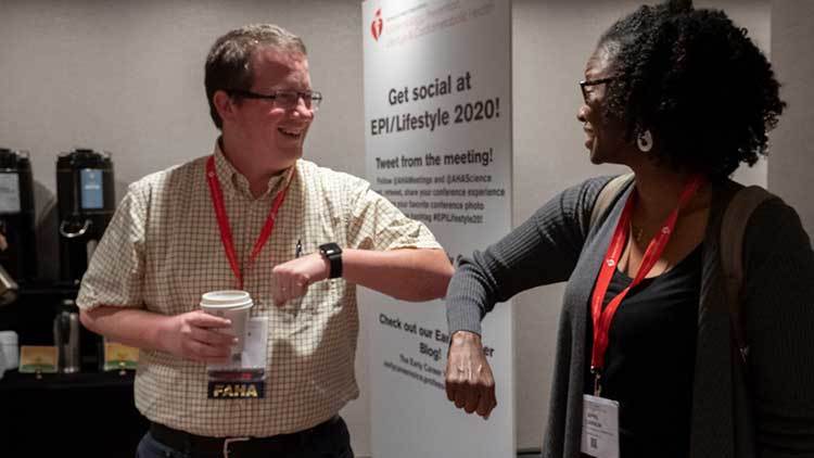 Attendees demonstrate the best way to greet a colleague or friend during flu season, and especially since CoVID-19 has been in the news. 