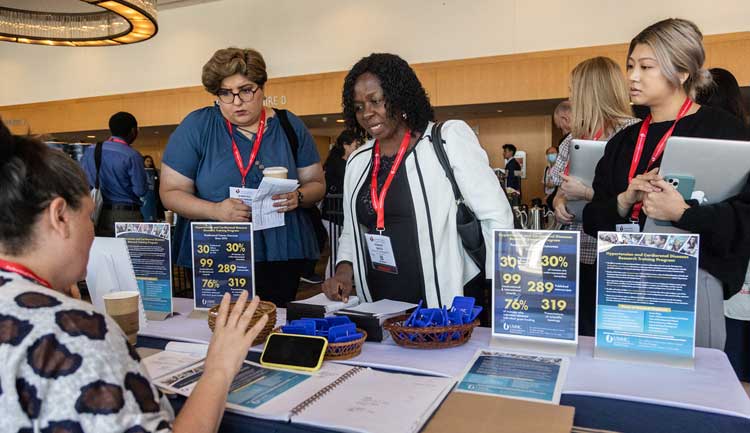 Attendees speak to an industry representative at Hypertension 2022.