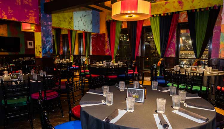 Photo of a restaurant space ready for a large dinner.