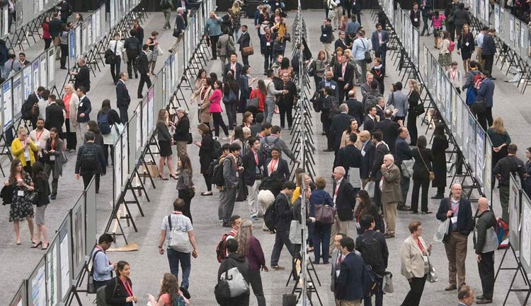 International Stroke Conference attendees are shown during a poster session.