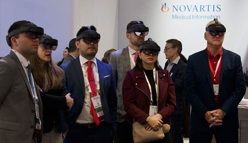 Conference visitors watch a simulated learning situation using virtual reality glasses in the SimZone.