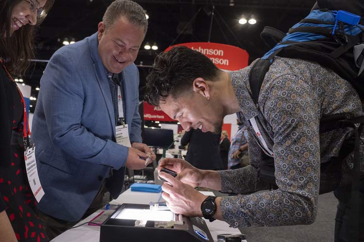 An attendee takes a photo of a machine in the Simulation Zone from #ISC25.