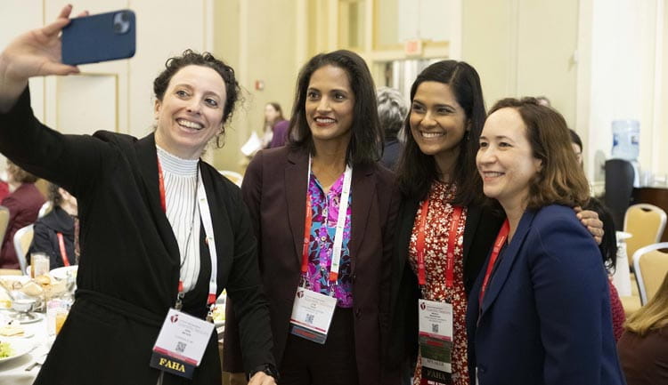 Four attendees pose for a selfie during #AHA23 in Philadelphia, PA.