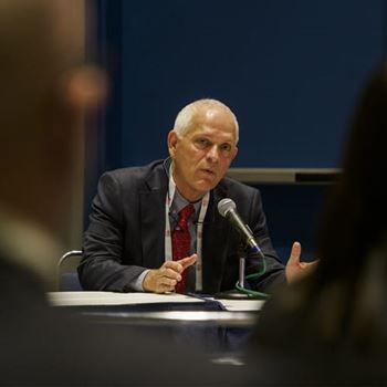 A speaker addresses audience members during the International Symposium at #AHA24.