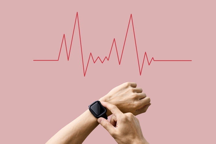 A stock photo of a person checking their smart watch for heart beat activity.