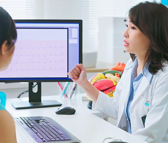 Young, Asian female cardiology doctor is explaining the electrocardiogram to patient