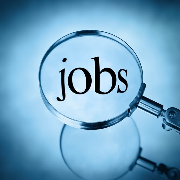 Magnifying glass with the word jobs magnified in blue tone