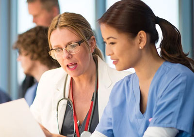 female doctor mentoring female student