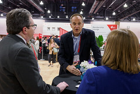 Researchers at heart - man talking with two others