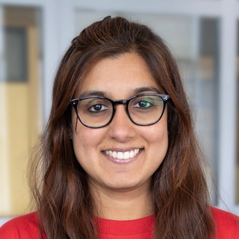 Headshot of woman wearing glasses and a red shirt