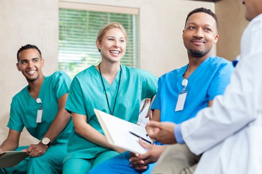attentive medical staff talk with colleague