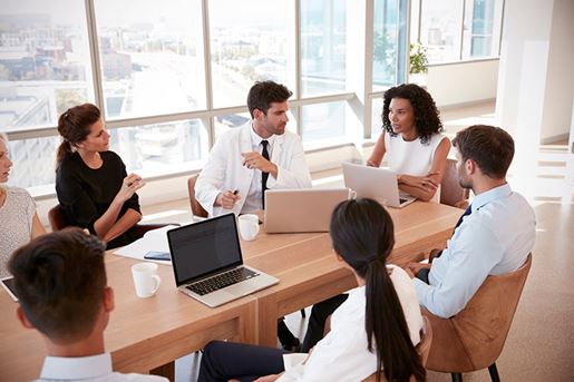medical staff meeting around table in hospital
