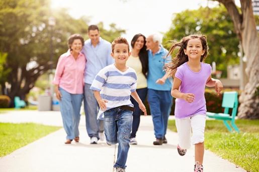 multi-generation family walking in park together