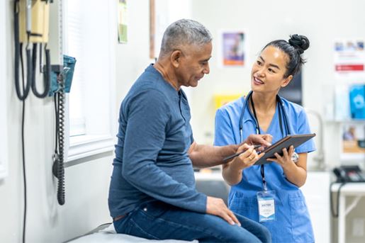 patient sitting on exam table talking to doctor