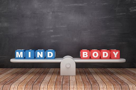 Seesaw Scale with MIND BODY Cubes on Chalkboard Background