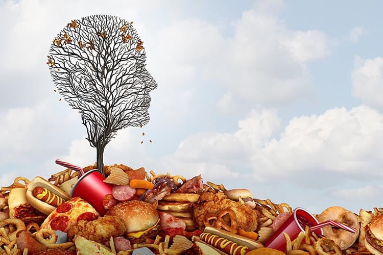 Illustration with mound of bad foods and bare tree at top shaped like a head 