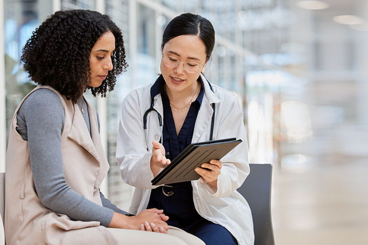 Doctor, woman patient and tablet for consulting with results, medical info