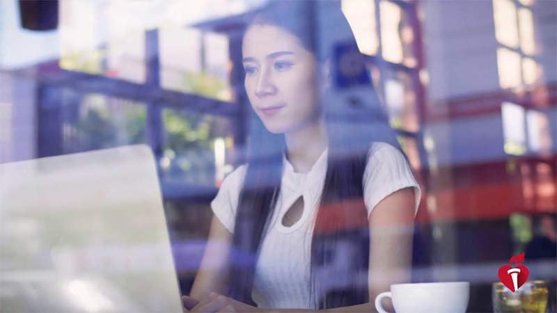Woman sitting on laptop at shop. "present your science from anywhere"