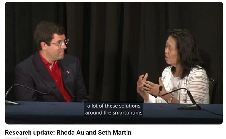 Drs. Martin and Au sitting behind a table facing each other