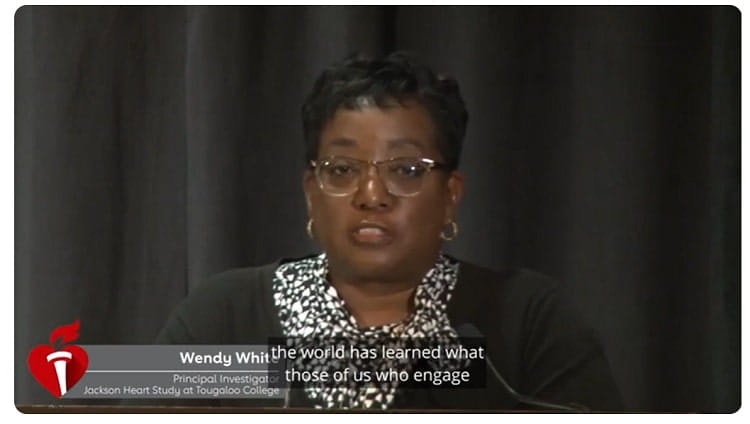 Dr. White standing behind a podium